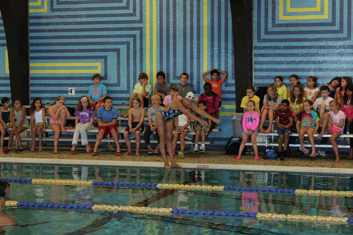 Olympic Gold Medalist Rebecca Soni instructs members of the Darien YMCA Piranhas. Contributed photo by Amy Kiser