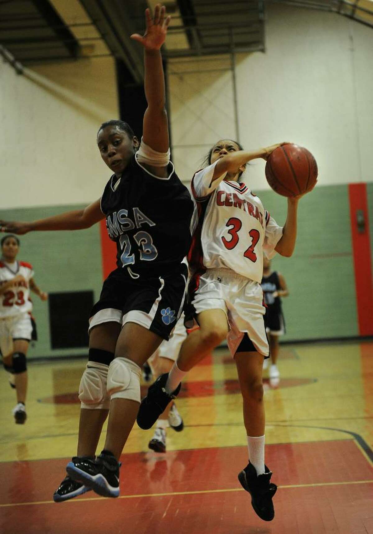 Bridgeport Central's Amber James, right drives to the basket on a fast break against SMSA defender Chelsea Bourne during Monday's matchup at Central High School in Bridgeport, January 25, 2010.