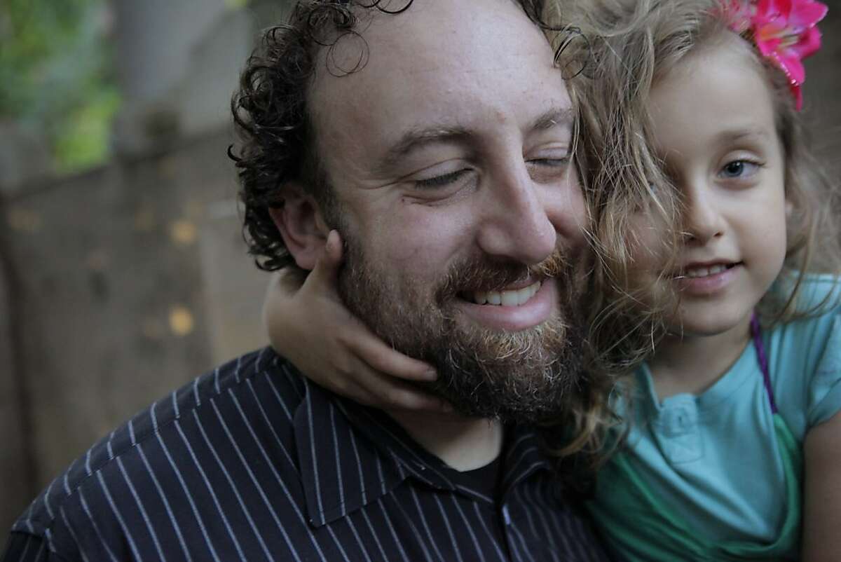 Joshua Safran with his daughter Sivan, 6, at their Oakland, Calif., home on Sunday, August 18, 2013. Safran has written a memoir about growing up off the grid with his free spirit mother - living in the woods, in buses, in half-finished cabins as she goes through a string of abusive relationships looking for counterculture utopia. Safran, an Oakland attorney most known for his pro-bono work to free a woman imprisoned for her abusive boyfriend's murder, reveals in his book Free Spirit why he is so passionate about helping battered women.