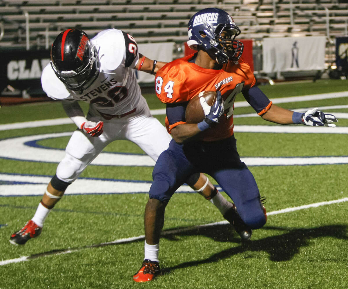 Brandeis wide receiver Larry Stephens (right) spins away from Stevens Romello Garcia at the goal line before scoring a 41-yard touchdown, his second of the night, during the second quarter of their Saturday game.