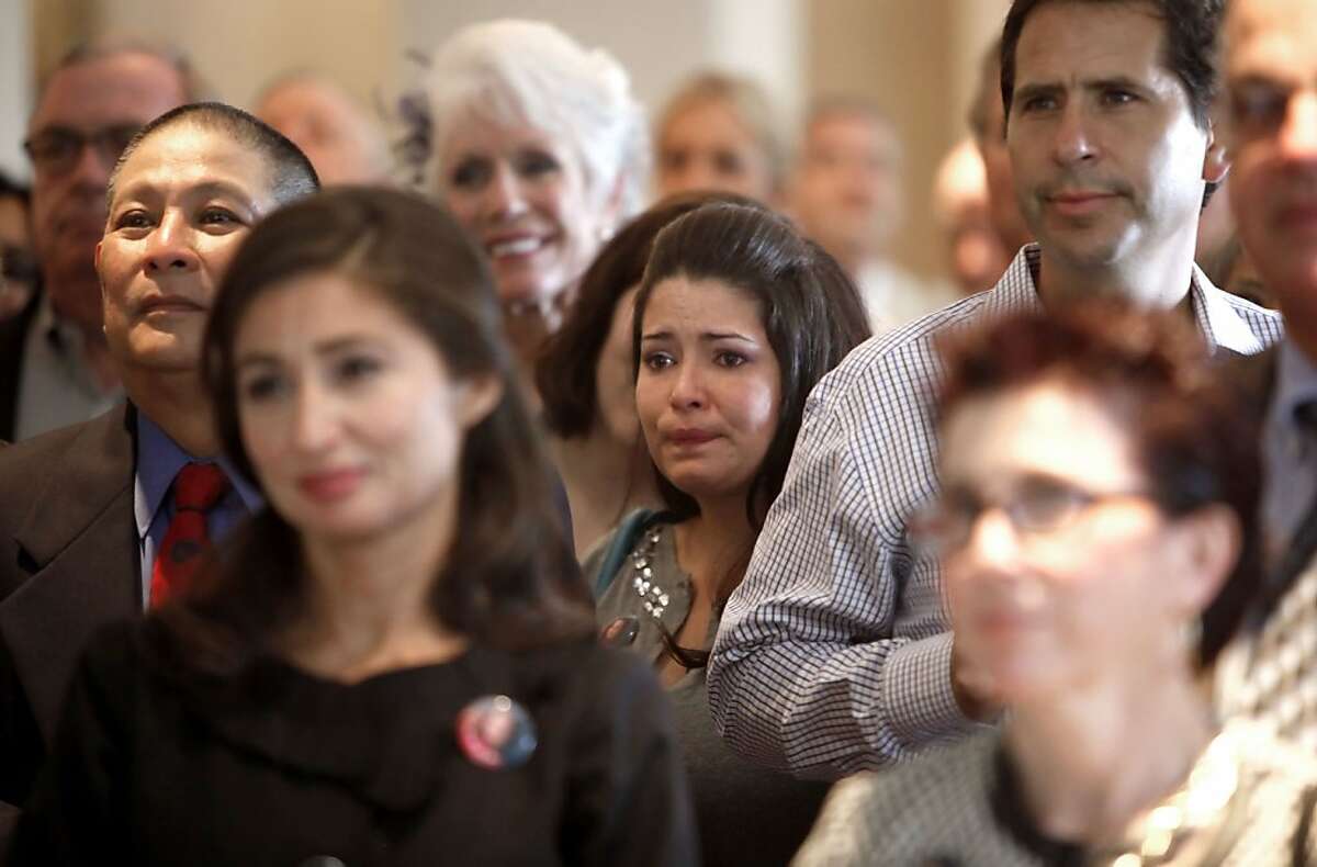 Katie Romanek, (center) who was kidnapped in 1994 and went missing at the age of 12 in Lodi, Ca., for twenty three hours watches a video about the life of Polly Klaas, along with guests gathered at the Fairmont Hotel on Tuesday Oct. 1, 2013, in San Francisco, Calif. Twenty years after the kidnap and murder of Polly Klaas Mark Klaas her father invited relatives, friends and law enforcement to gather together to remember Polly and those still missing.