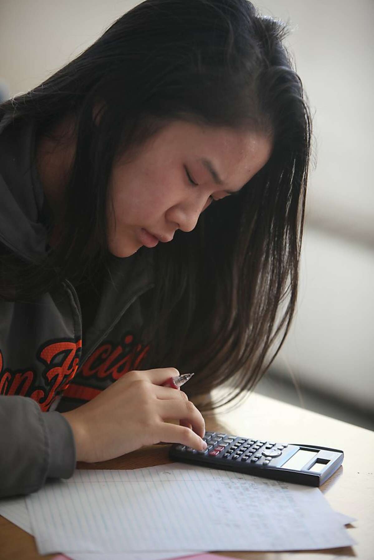 Chelsea Nguyen, 15, works on classwork during an Algebra II class at Phillip and Sala Burton Academic High School on Wednesday, October 2, 2013 in San Francisco, Calif.
