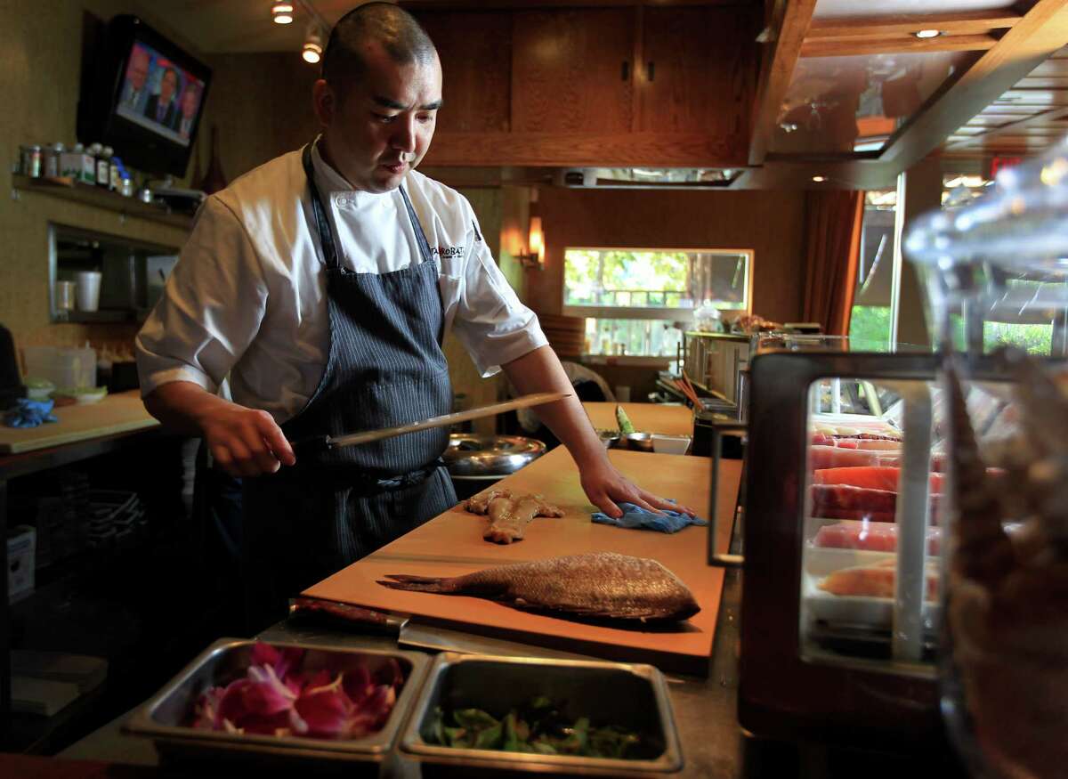 Chef Manabu Horiuchi of Kata Robata, cuts fish at the sushi bar, Wednesday, Sept. 25, 2013, in Houston. ( Karen Warren / Houston Chronicle )