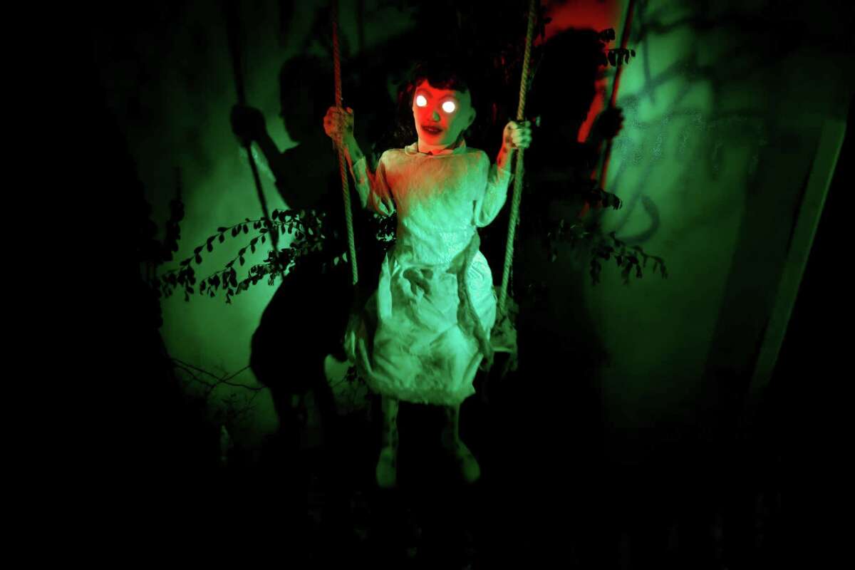 A spooky child in a swing greets visitors to the haunted house at the National Museum of Funeral History. The museum also will feature a Dracula exhibit and a Halloween car show.