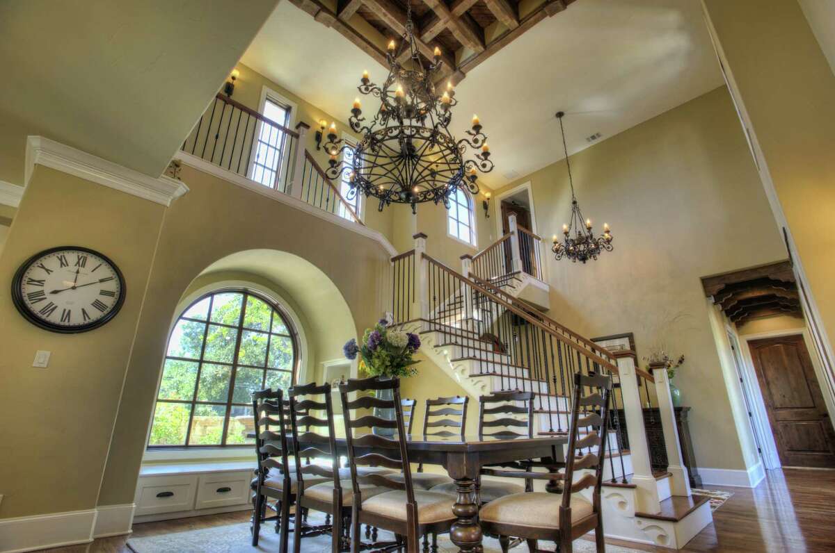 Wood coffers on a soaring entry ceiling serve as a backdrop to a massive iron chandelier.