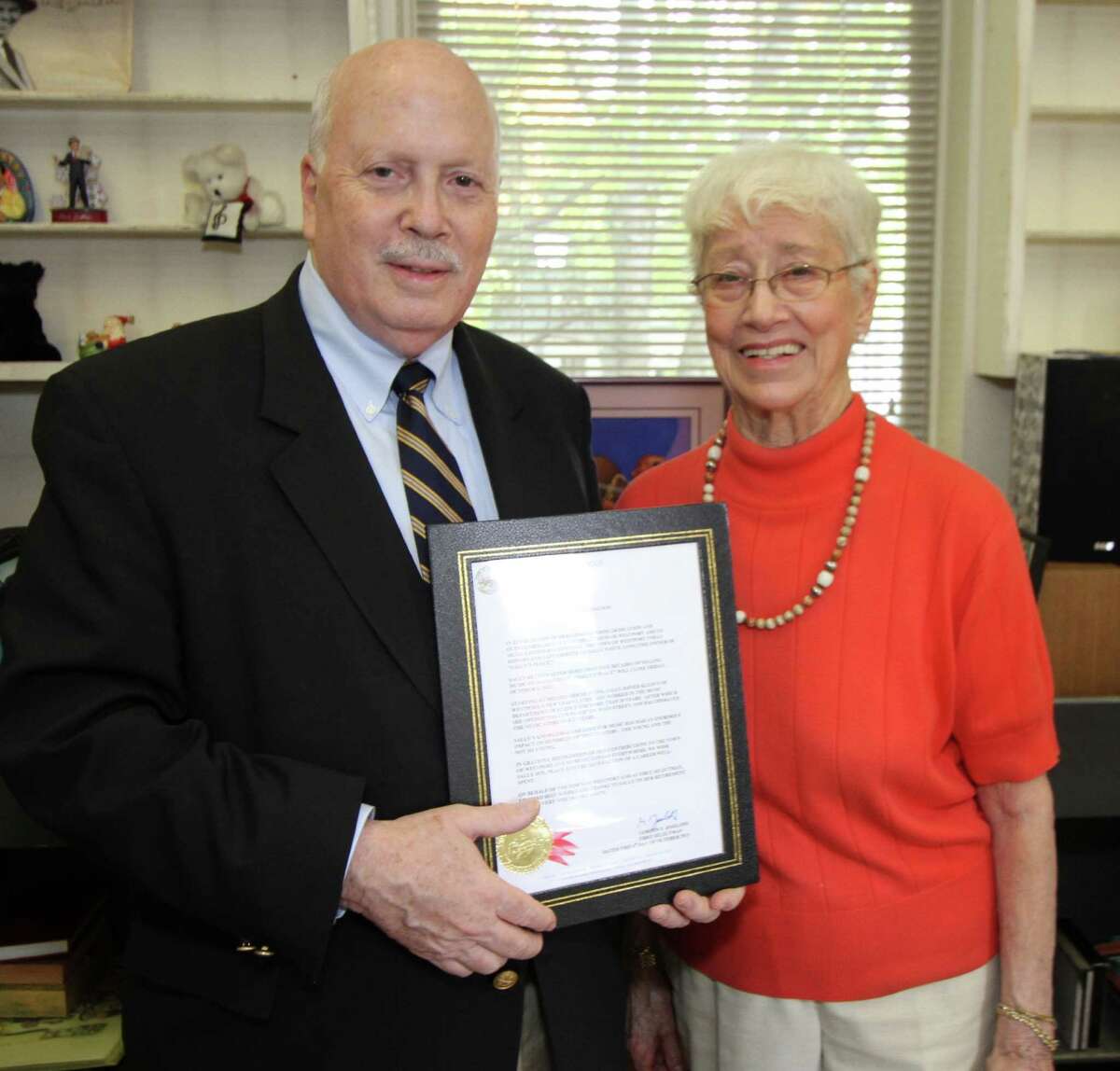 First Selectman Gordon Joseloff displays a commendation from the town to Sally White, before presenting it to her at town hall on Thursday, Oct. 4. White provided music to several generations of Westporters over a half century before closing her Sally's Place record shop this summer.