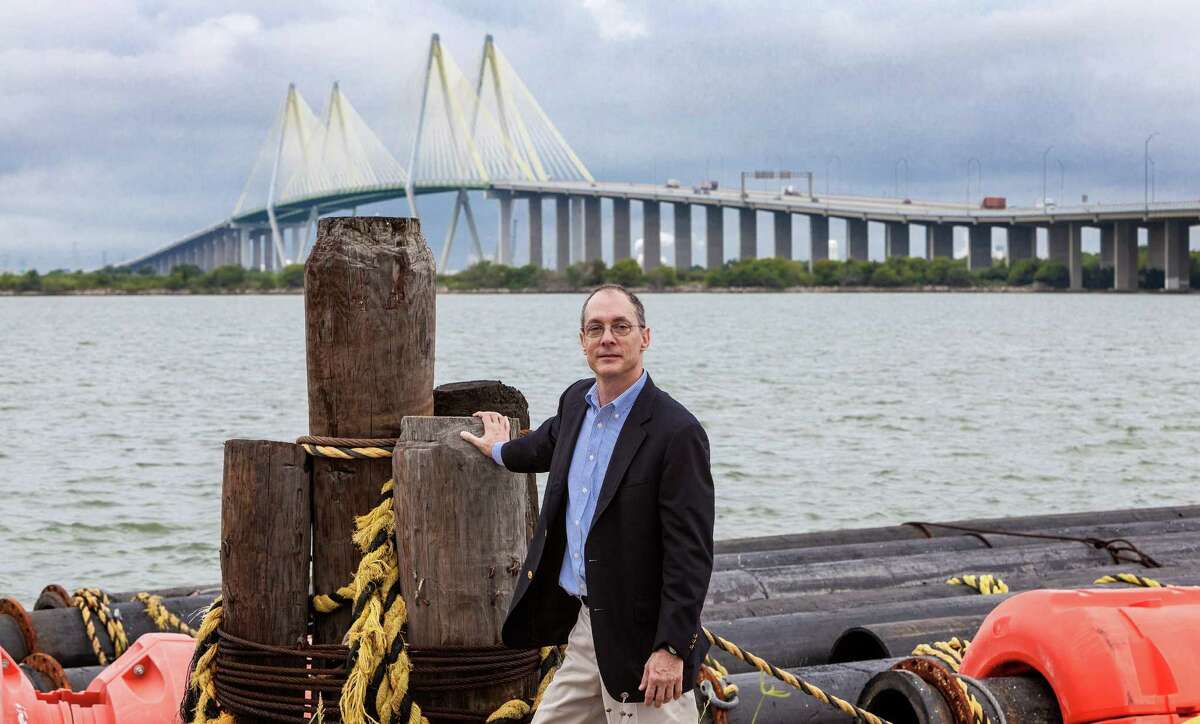 Thomas M. Colbert, Associate Professor from the Gerald D. Hines College of Architecture, UH, stands on the area northeast of the Fred Hartman Bridge, Baytown. He proposes a huge levy starting here and extending all the way across the Houston Ship Channel with giant gates to admit ship traffic under the Fred Hartman Bridge in the distance. 9/30/13 (Craig H. Hartley/For the Chronicle)