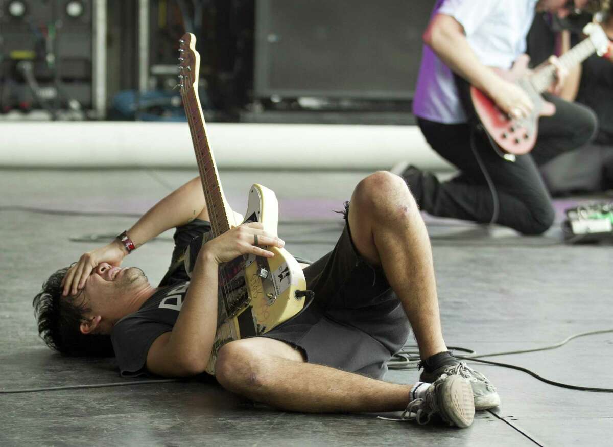 Zac Carper, of the Los Angeles skate punk band FIDLAR, falls to the stage near the end of his set at the Austin City Limits Music Festival at Zilker Park in Austin, Texas, Friday, October 4, 2013. 