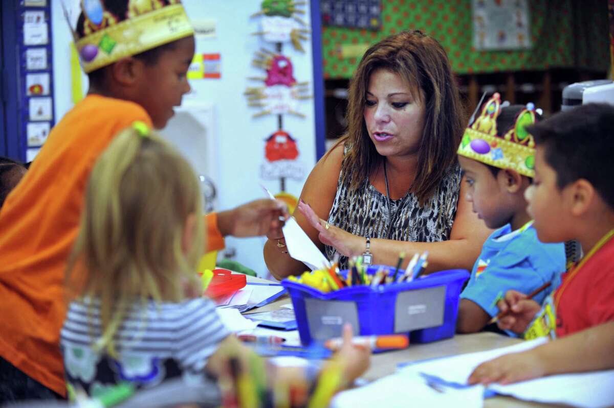 Elizabeth Smith, a kindergarten teacher at Hayestown Avenue Elementary School, works with her class during the conferencing portion of a writing workshop, Wednesday, Oct. 2, 2013. Smithis Danbury's Teacher of the Year for 2013.
