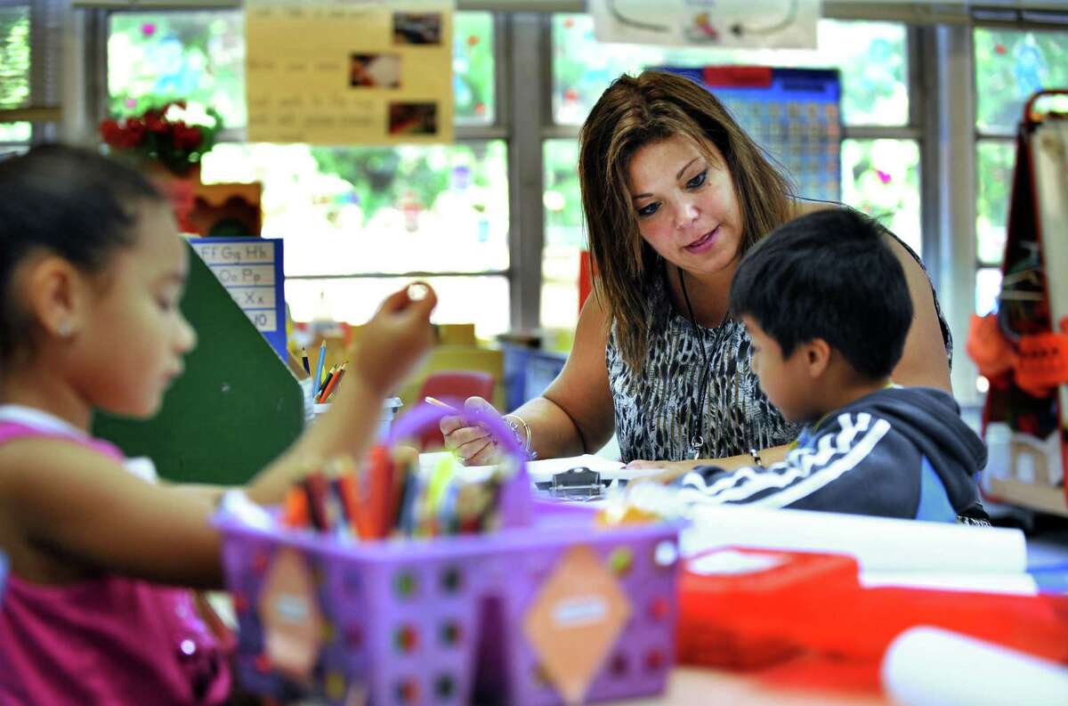 Elizabeth Smith, a kindergarten teacher at Hayestown Avenue Elementary School, is Danbury, Conn's teacher of the year for 2013. Wednesday, Oct. 2, 2013, she works with Eric Patino during the conferencing portion of a writing workshop.