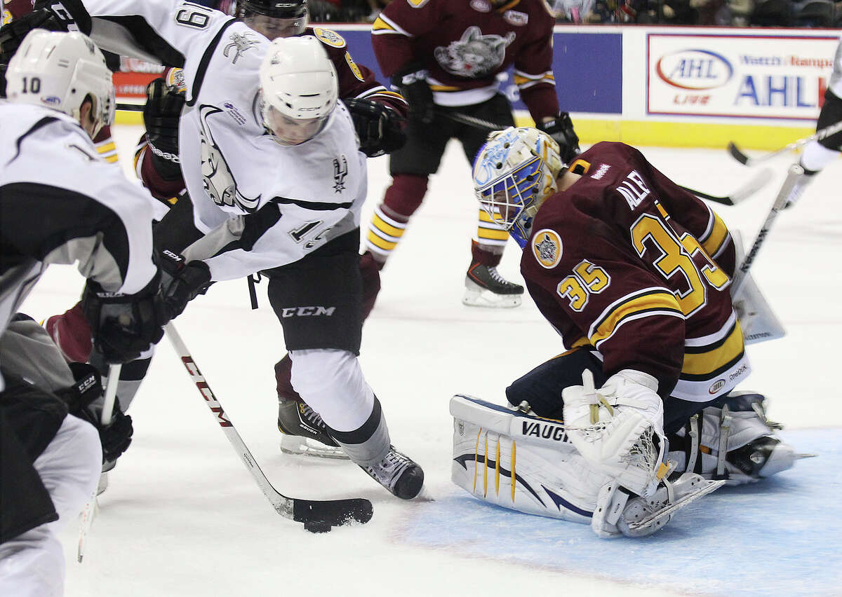 Rampage's Garrett Wilson (19) attempts to score against Chicago Wolves goalie Jake Allen (35) Pat Cannone (21) during the Rampage's home opener on Friday, Oct. 4, 2013.