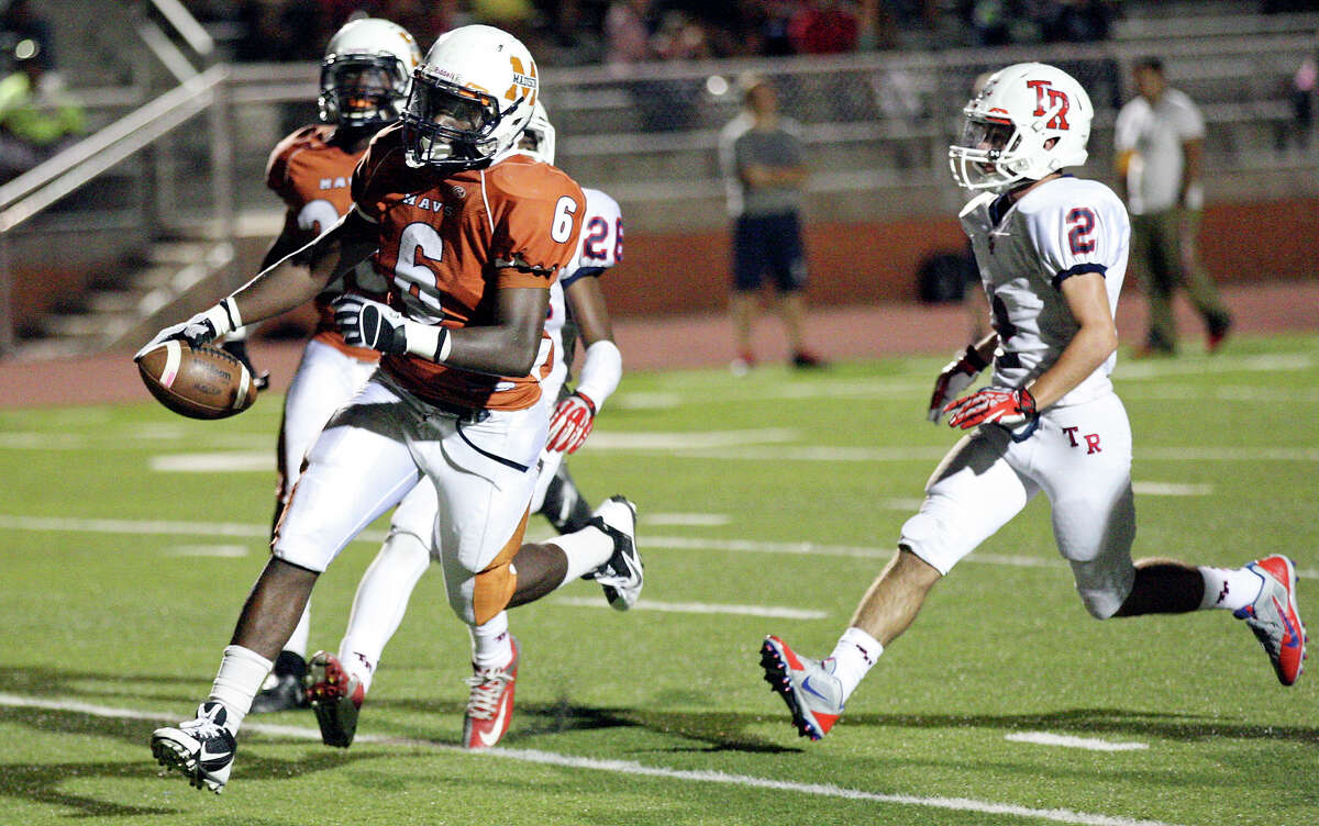Madison's Dominique Daniels scores a touchdown ahead of Roosevelt's Tyler Tupper during first half action Friday Oct. 4, 2013 at Heroes Stadium.