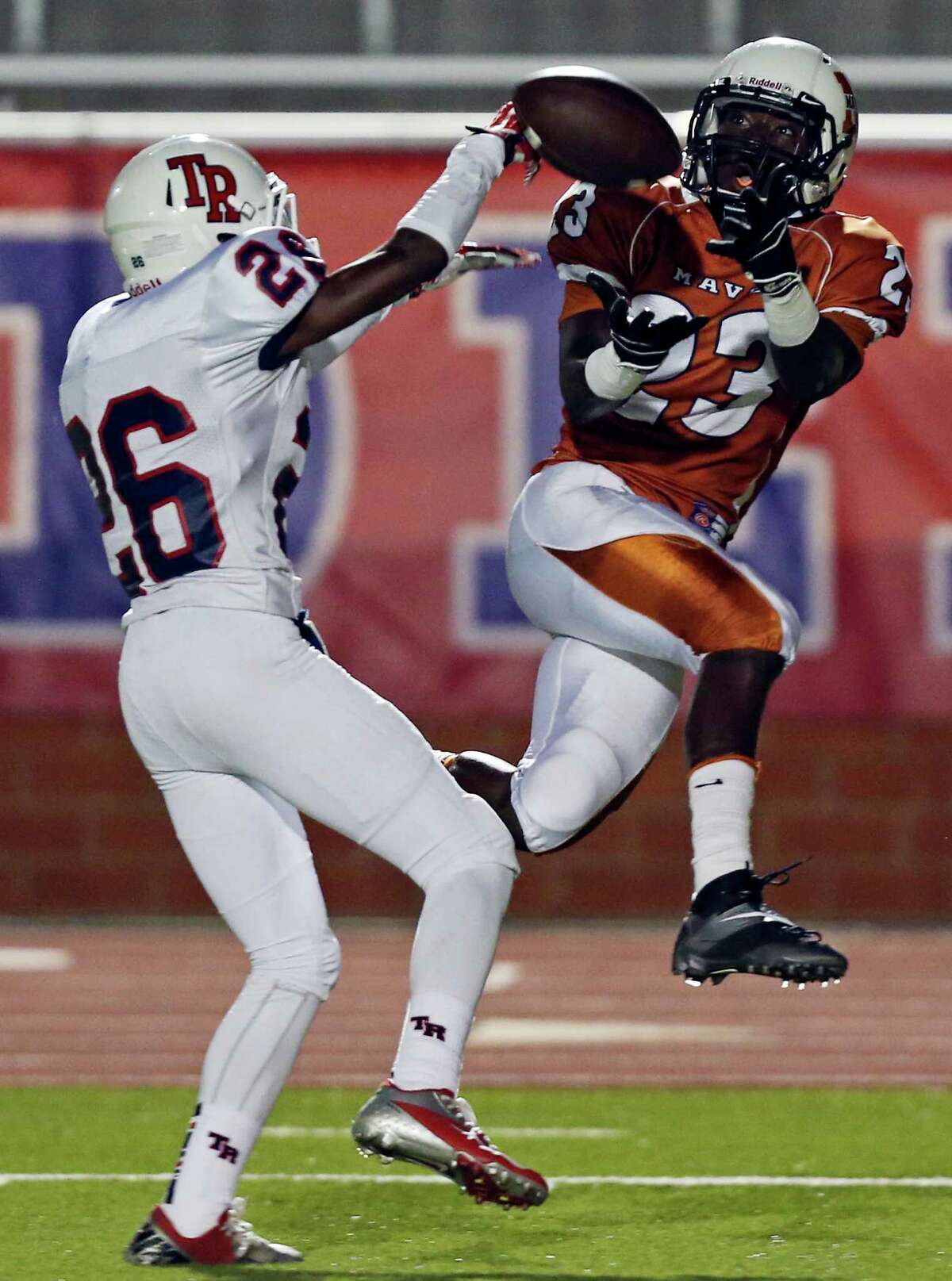 Madison's Ja'Michael Brown goes up for a pass as he is defended by Roosevelt's Will Porter during first half action Friday Oct. 4, 2013 at Heroes Stadium. The pass was incomplete.