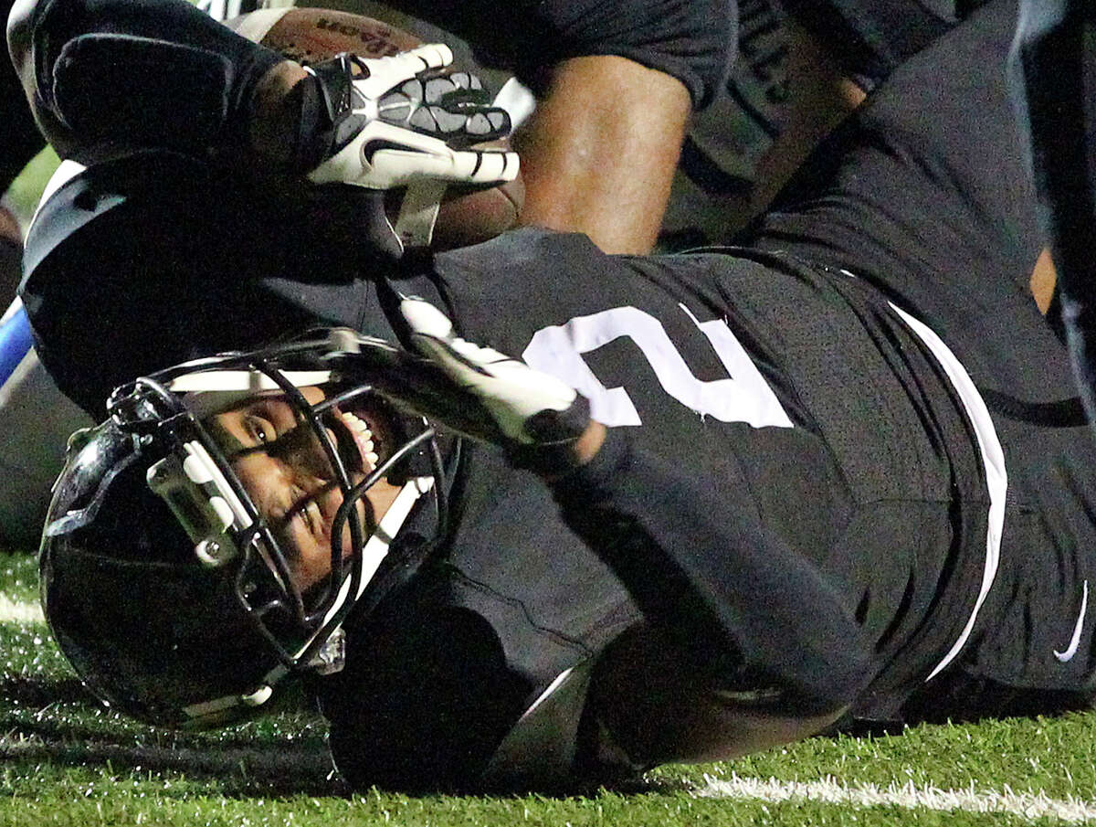 Colton Applewhite tries to get the ball over the goal line in the first half for the Matadors as Seguin hosts Alamo Heights at Matador Stadium on October 4, 2013.
