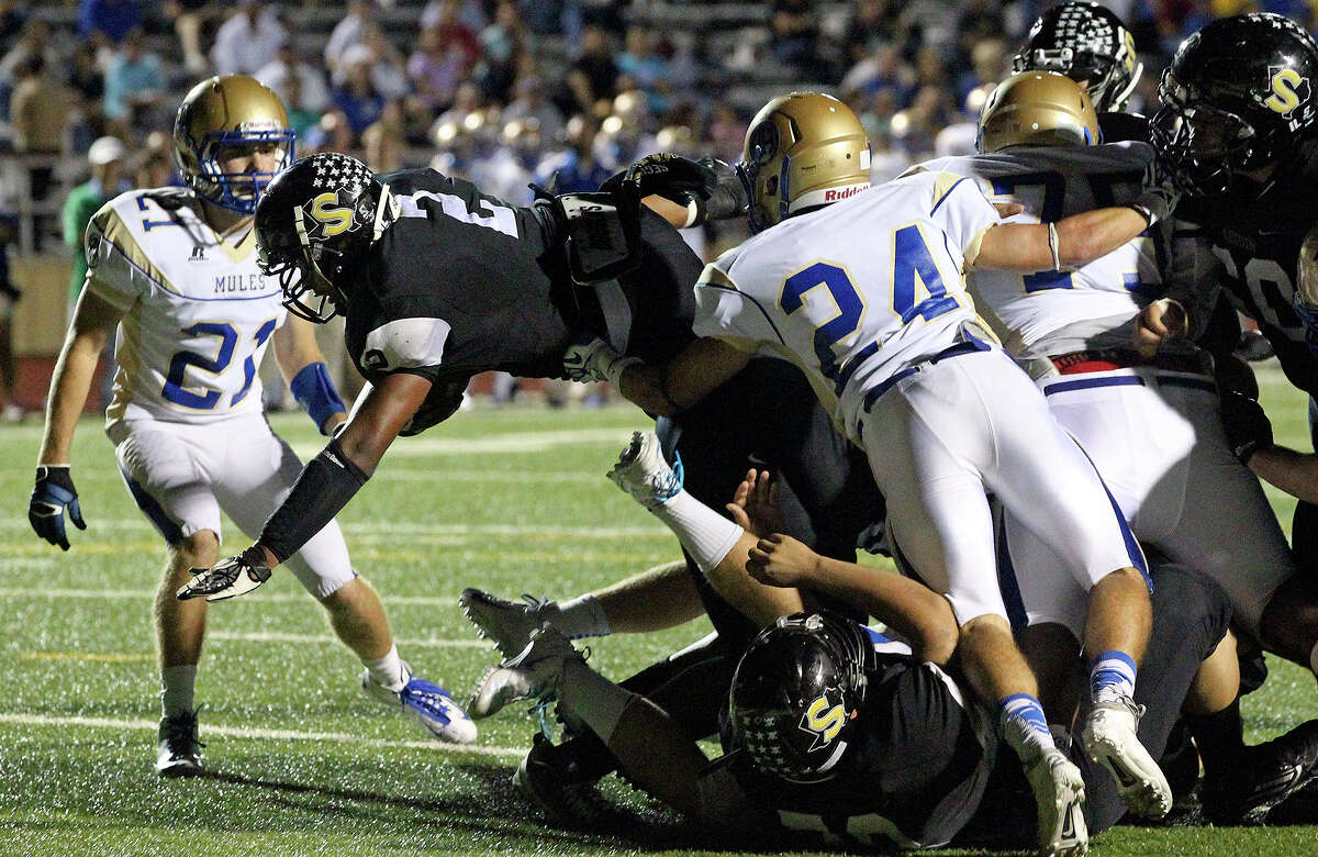 Colton Applewhite gets the ball over the goal line in the first half for the Matadors as Seguin hosts Alamo Heights at Matador Stadium on October 4, 2013.