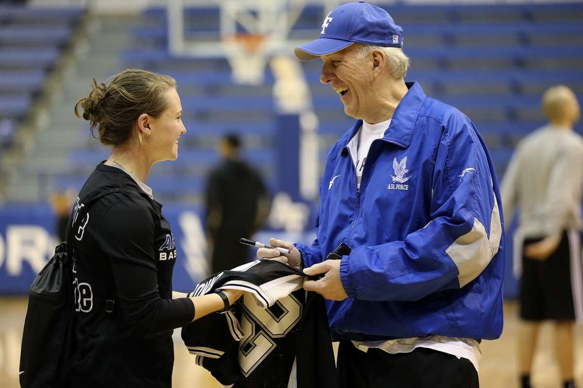 San Antonio Spurs Head Coach Gregg Popovich signs an autograph for U.S. Air Force Women's Basketball guard Izzie Englehart, 18, after a light team workout on their last day at the United State Air Force Academy in Colorado Springs, Colorado, Friday, Oct. 4, 2013. The Spurs spent the week training at the academy and will play a scrimmage at the AT&T Center on Sunday. It will be open to the public.