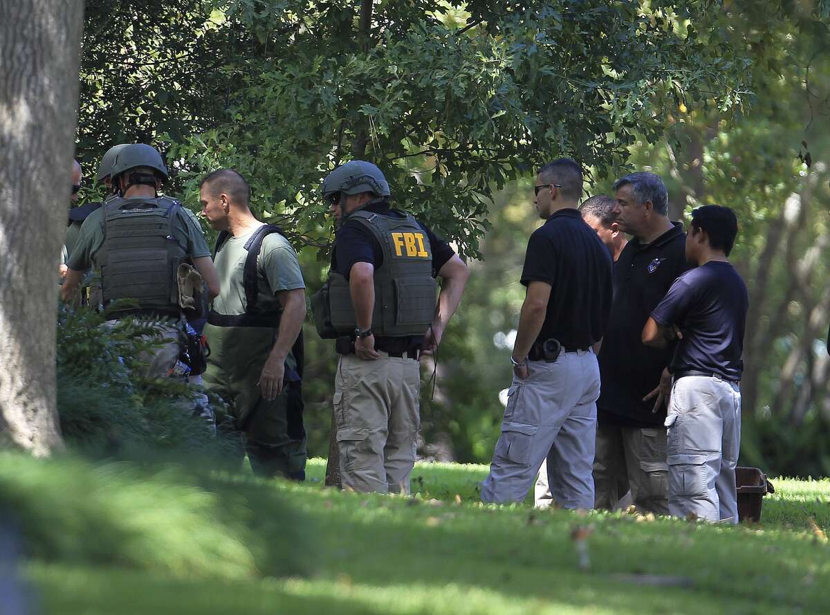 Members of the FBI prepare to detonate an unknown substance at a home at 411 Fall River Road in the Memorial area, Saturday, Oct. 5, 2013, in Houston.
