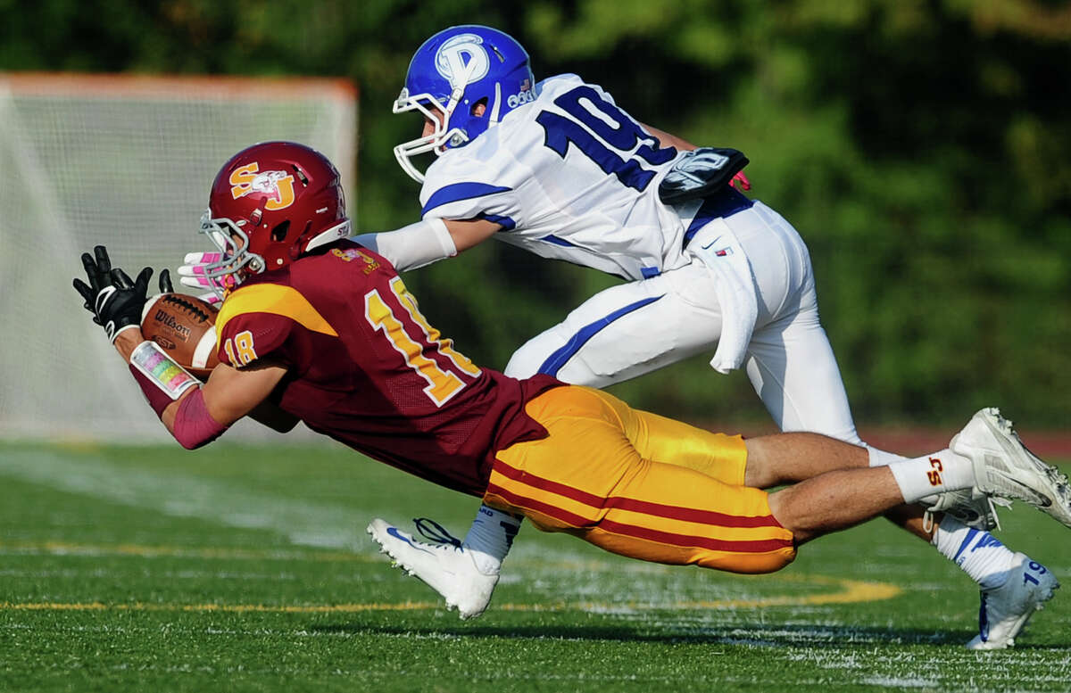 St. Joseph's Alex Pinto attempts to intercept a pass intended for Darien's Griffin Ross, during high school football action in Trumbull, Conn. on Saturday October 5, 2013. Pinto fumbled the ball.