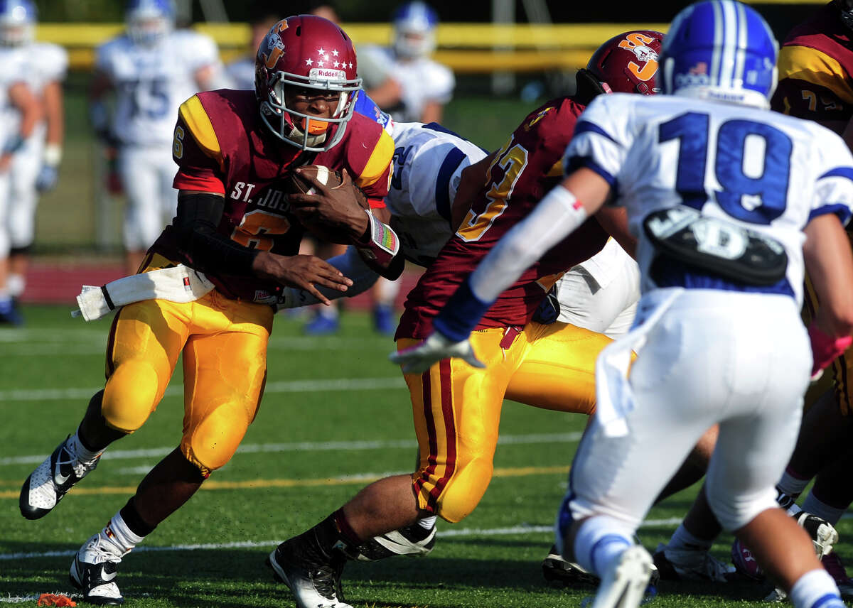 St. Joseph's Mufasa Abdul-Basir carries the ball on his way to a touchdown against Darien, during high school football action in Trumbull, Conn. on Saturday October 5, 2013.