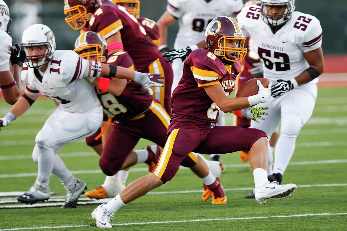 Harlandale's Eddie Pedroza (second from right) picks up yardage during the first half of their game at Harlandale Memorial Stadium on Oct. 4, 2013. Harlandale beat the Tigers 28-17. MARVIN PFEIFFER/ mpfeiffer@express-news.net