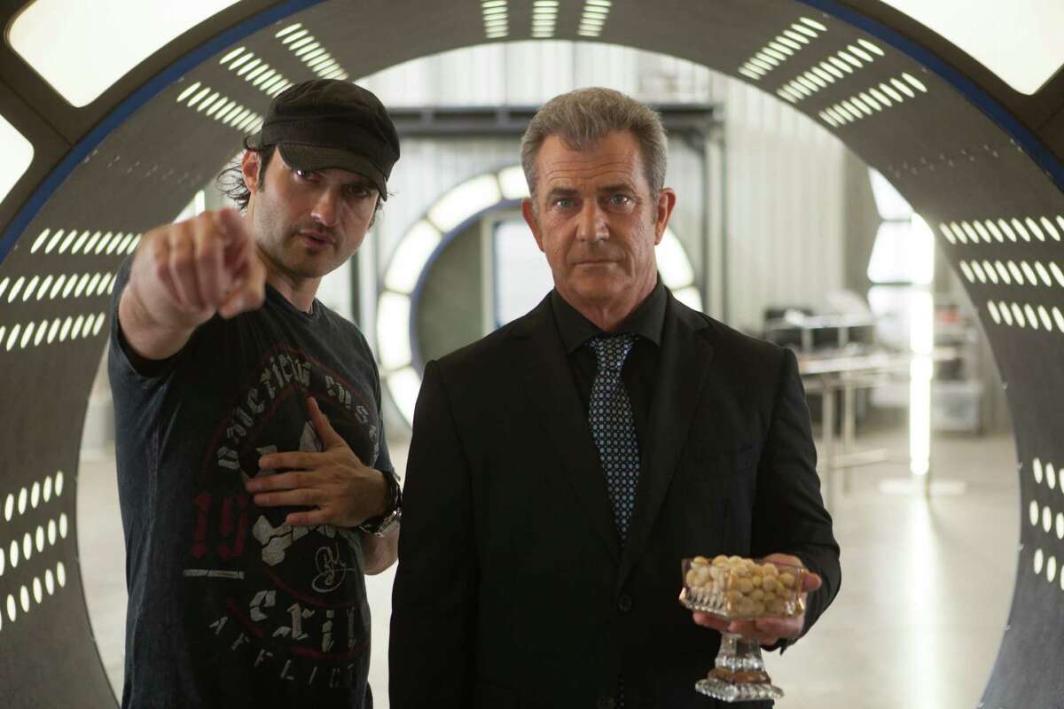 Director Robert Rodriguez works with Mel Gibson on the set of “Machete Kills.”