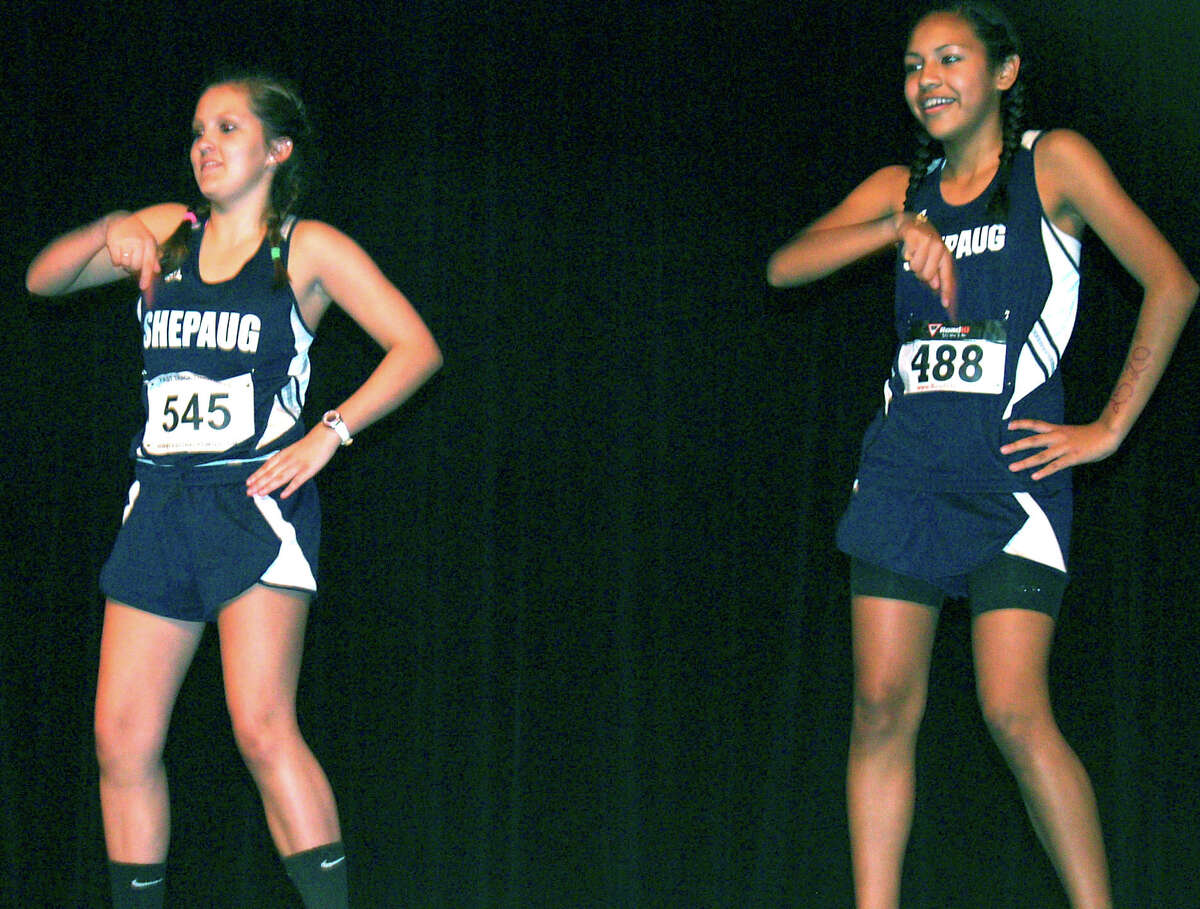 Jemma Roche, left, and Daniela Cespedes enact "The Evolution of Dance" in tandem with members of the Spartan girls' cross country team during the Shepaug Valley High School sophomore class' annual talent show, Oct. 4, 2013 in Washington. Courtesy of Shepaug Valley High School