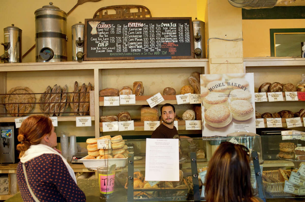 Kenji O’Sullivan helps customers at Model Bakery in St. Helena, where the English muffin is so highly coveted, there’s a limit of six per customer.