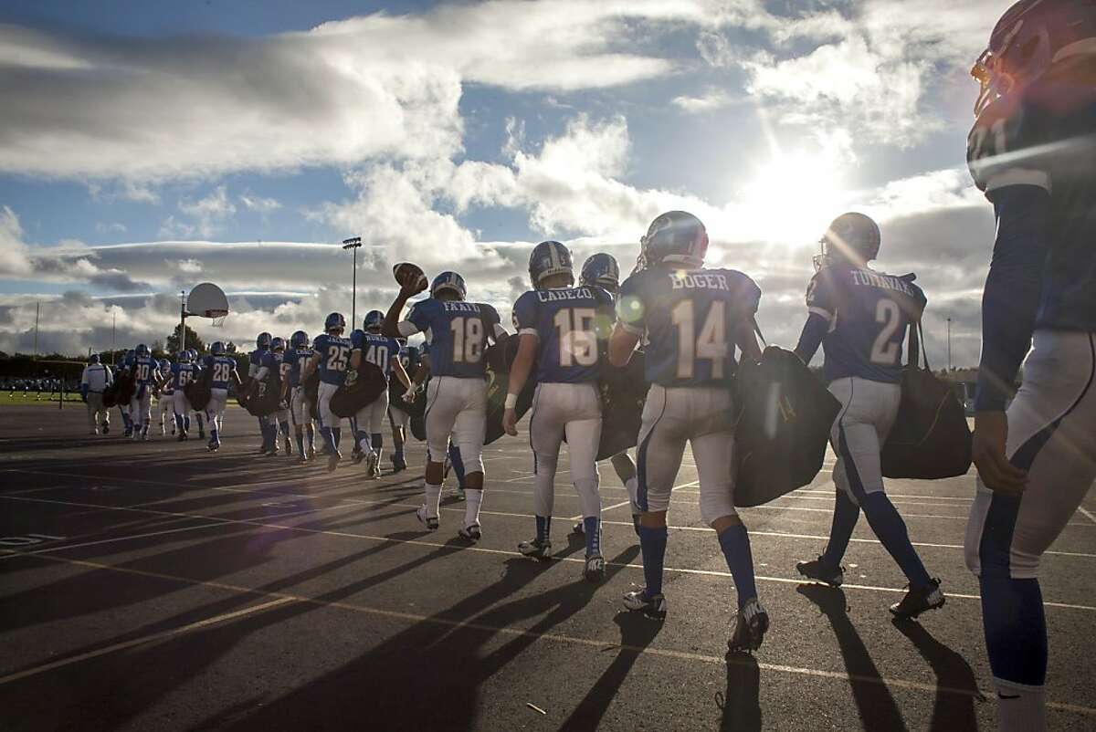 Junipero Serra high school's football team, the Padres, walks out onto the field before a game at Encinal high school against the Jets in Alameda on September 21st 2013.