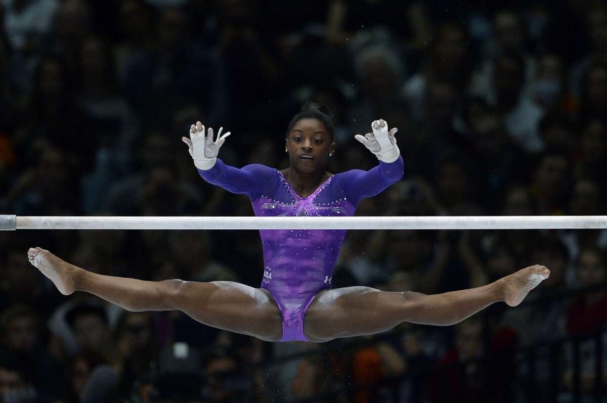 Simone Biles competes in the uneven bars event of the apparatus final on Sa...