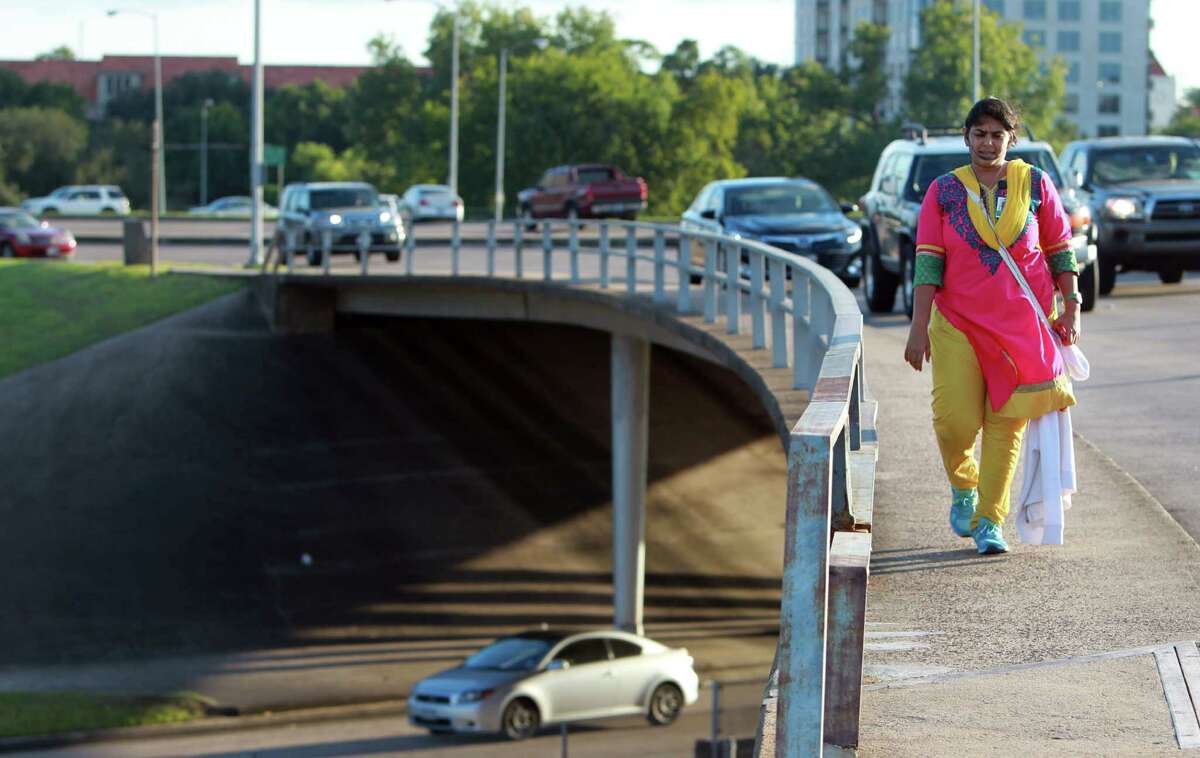 Despite her unease with vehicles passing so close by, Priyanka Gupta crosses the Waugh bridge Thursday over Memorial Drive.