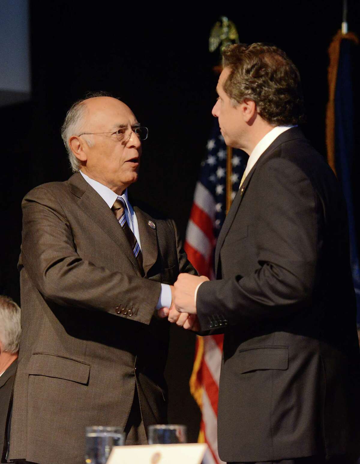 Hector Ruiz, left, chairman and CEO of Advanced Nanotechnology Solutions, Inc. and Gov. Andrew Cuomo meet Thursday, Oct. 10, 2013, in Utica, N.Y., following the announcement of Nano Utica. The consortium consists a group of more than six leading tech companies and will include a $1.5 billion investment. (Mark DiOrio / Observer-Dispatch) ORG XMIT: NYUTI