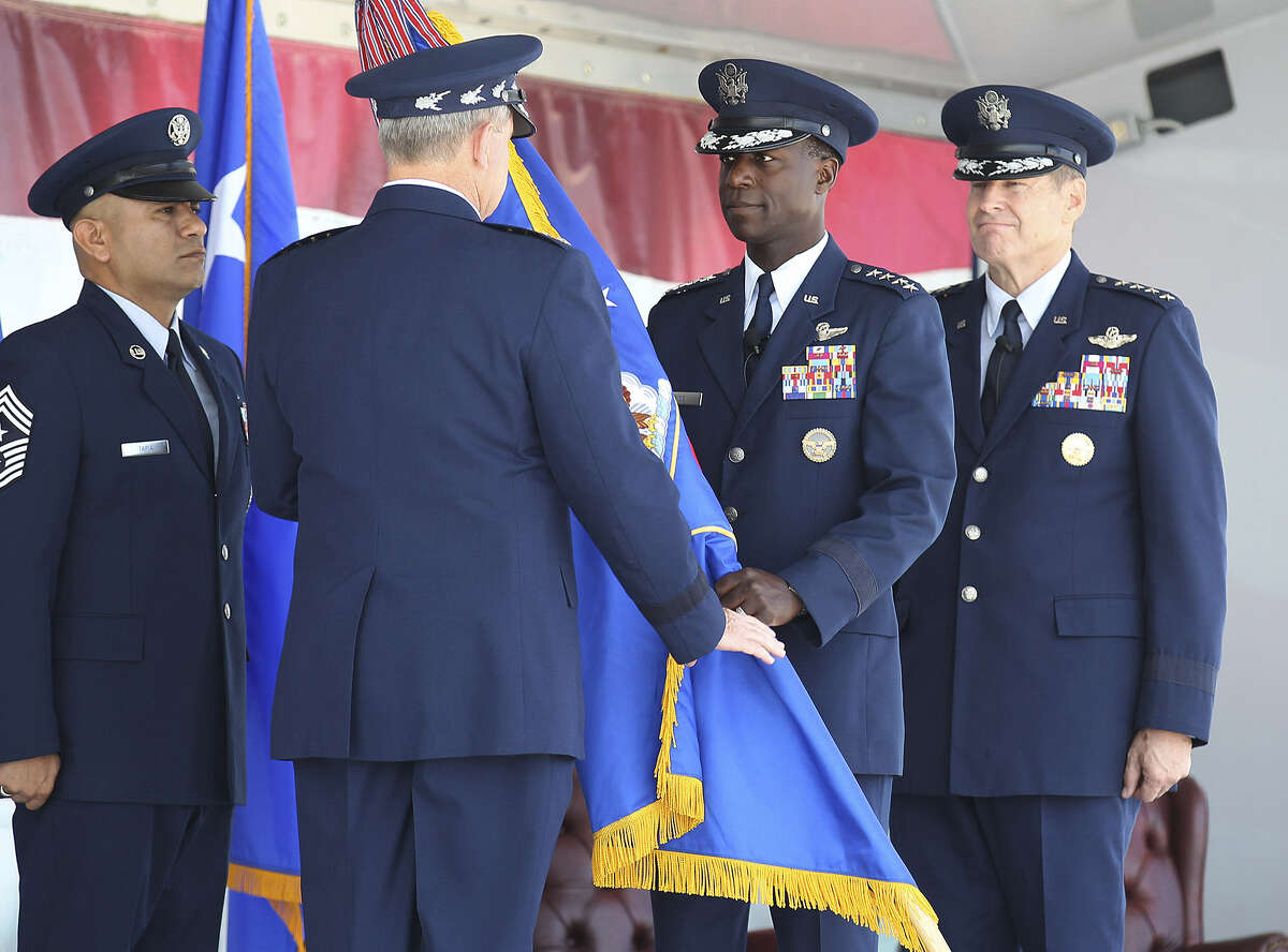 Gen. Edward Rice, Jr. (center, facing camera), 57, relinquishes the command flag to Gen. Mark Welsh, chief of staff of the Air Force, as Gen. Robin Rand waits to accept the banner.