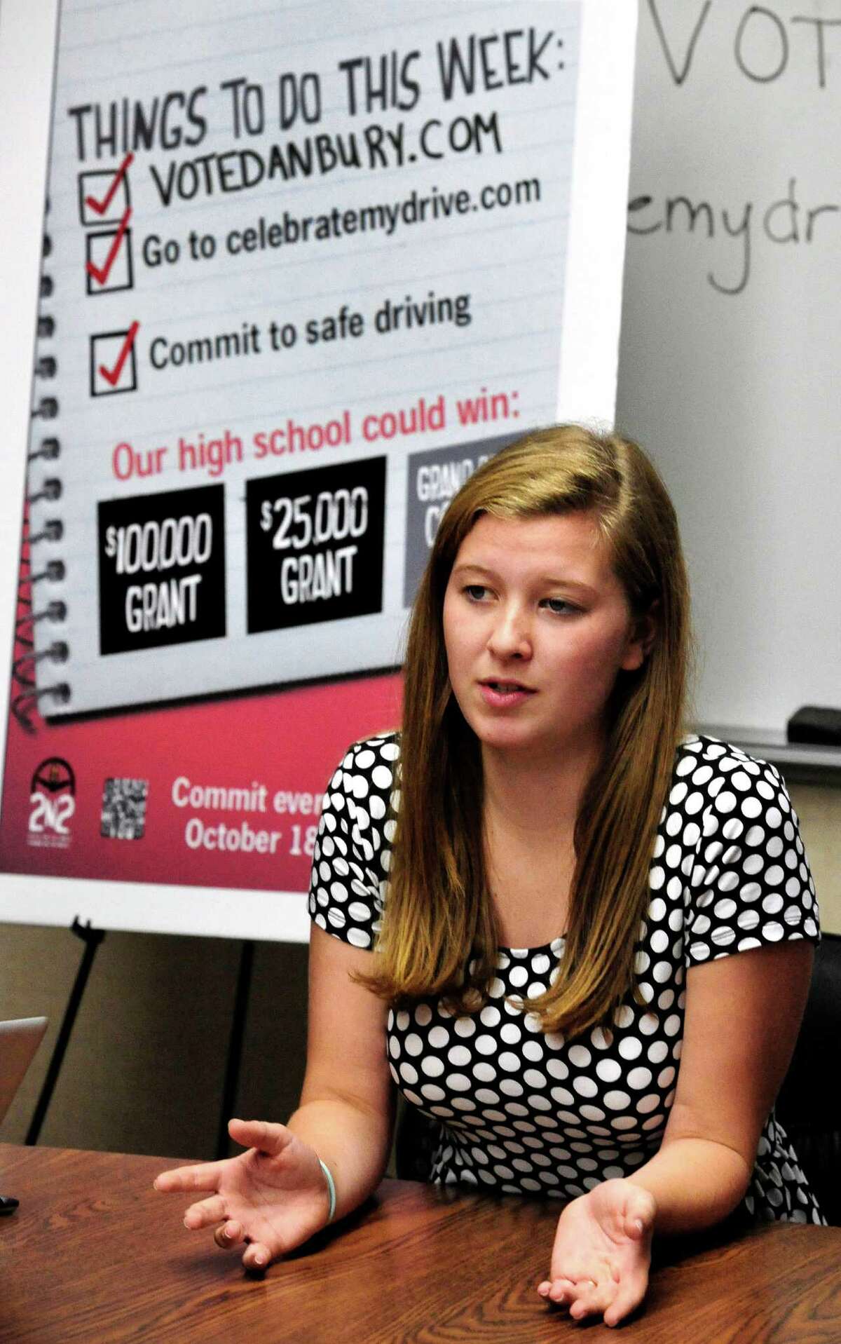 Kate Shannon, a Danbury High School senior class student leader, explains a citywide project to have people pledge that they won't text and drive, during a meeting at the school Friday, Oct. 11, 2013. If the school gets the most pledges in the contest run by State Farm Insurance, it would win $100,000 and an appearance by singer Kelly Clarkson.