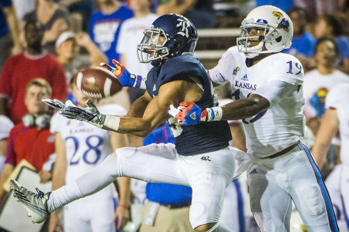 Rice cornerback Bryce Callahan (left) intercepts a pass intended for Kansas wide receiver Justin McCay during the first half of the Owls' 23-14 non-conference victory at Rice Stadium in Houston on Sept. 14.