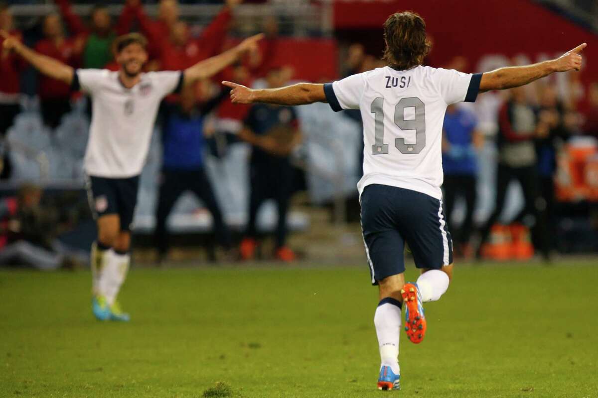 KANSAS CITY, KS - OCTOBER 11: Graham Zusi #19 of the U.S. Men's National Soccer Team celebrates after scoring the first goal of the game against Jamaica midway in the second half at Sporting Park on October 11, 2013 in Kansas City, Kansas.
