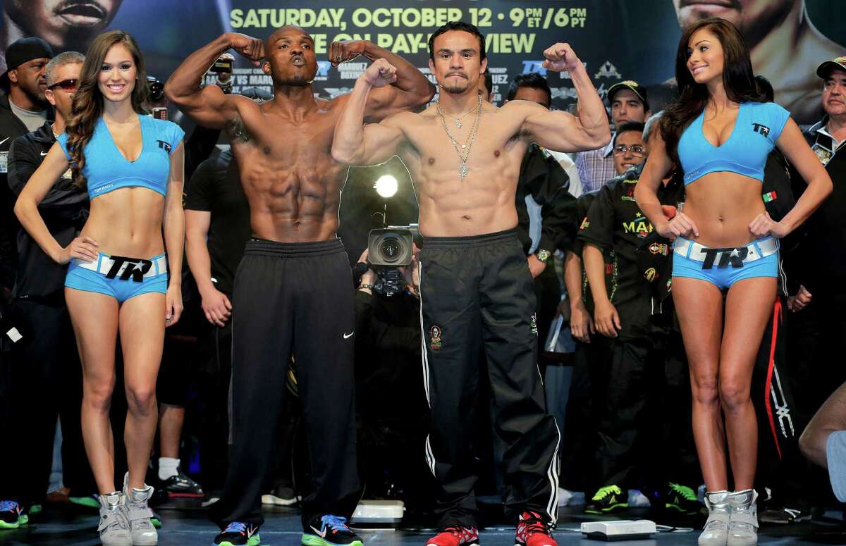 Timothy Bradley, center left, and Juan Manuel Marquez pose for photos after the weigh-in for their Saturday WBO welterweight title fight, Friday, Oct. 11, 2013, in Las Vegas. (AP Photo/Julie Jacobson) ORG XMIT: NVJJ110