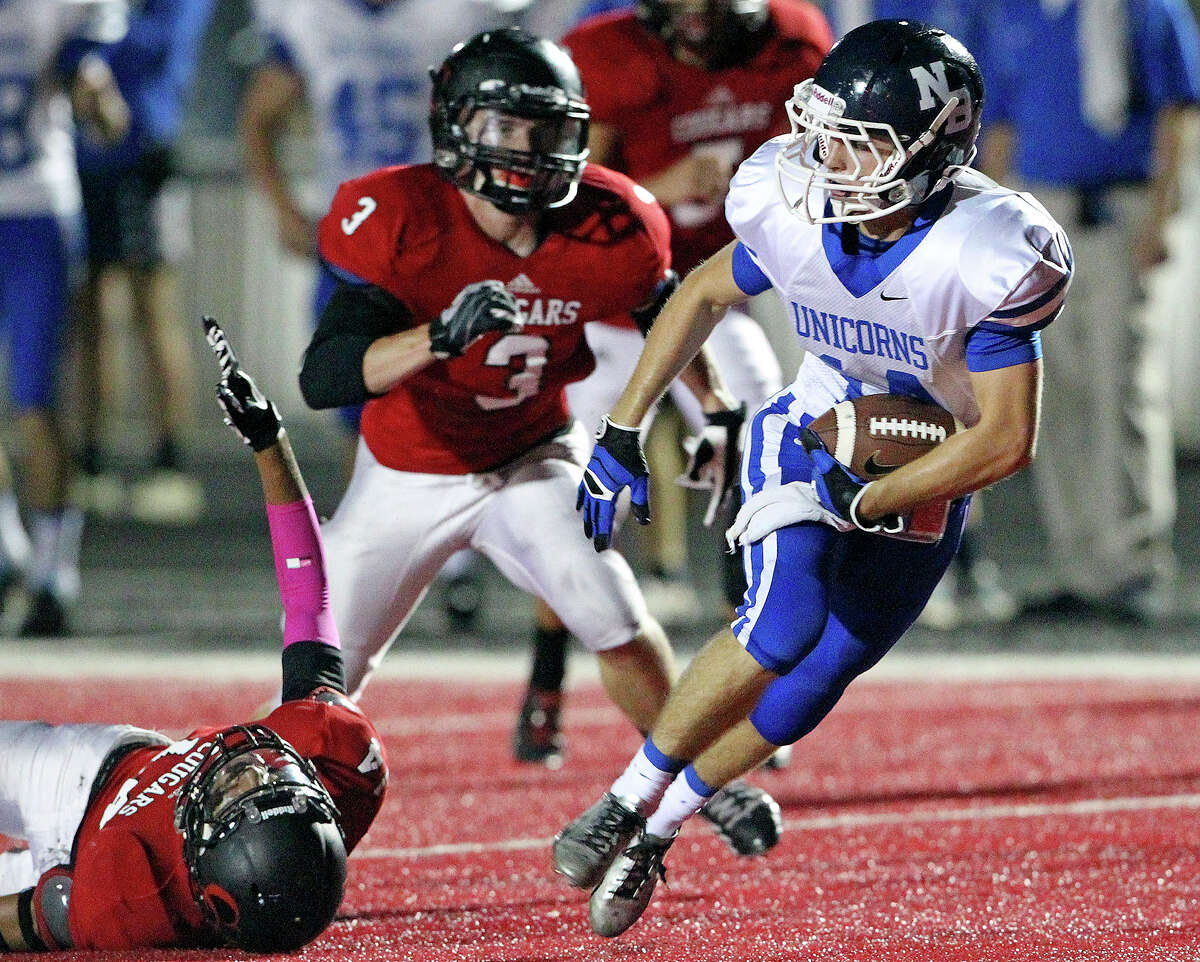 New Braunfels receiver John Tysdale gets behind Jordan Holmes (14) and James Smith for a touchdown in the first half as Canyon hosts New Braunfels in the Wurst Bowl at Canyon High School Stadium on October 11, 2013.
