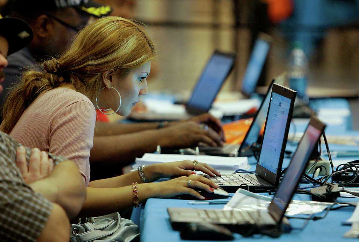 Antonia Alejandre uses one of several laptop computers set up Saturday at the Be Covered Houston Care Fair, which is part of a statewide education and outreach campaign sponsored by Blue Cross and Blue Shield at the Reliant Center in Houston.