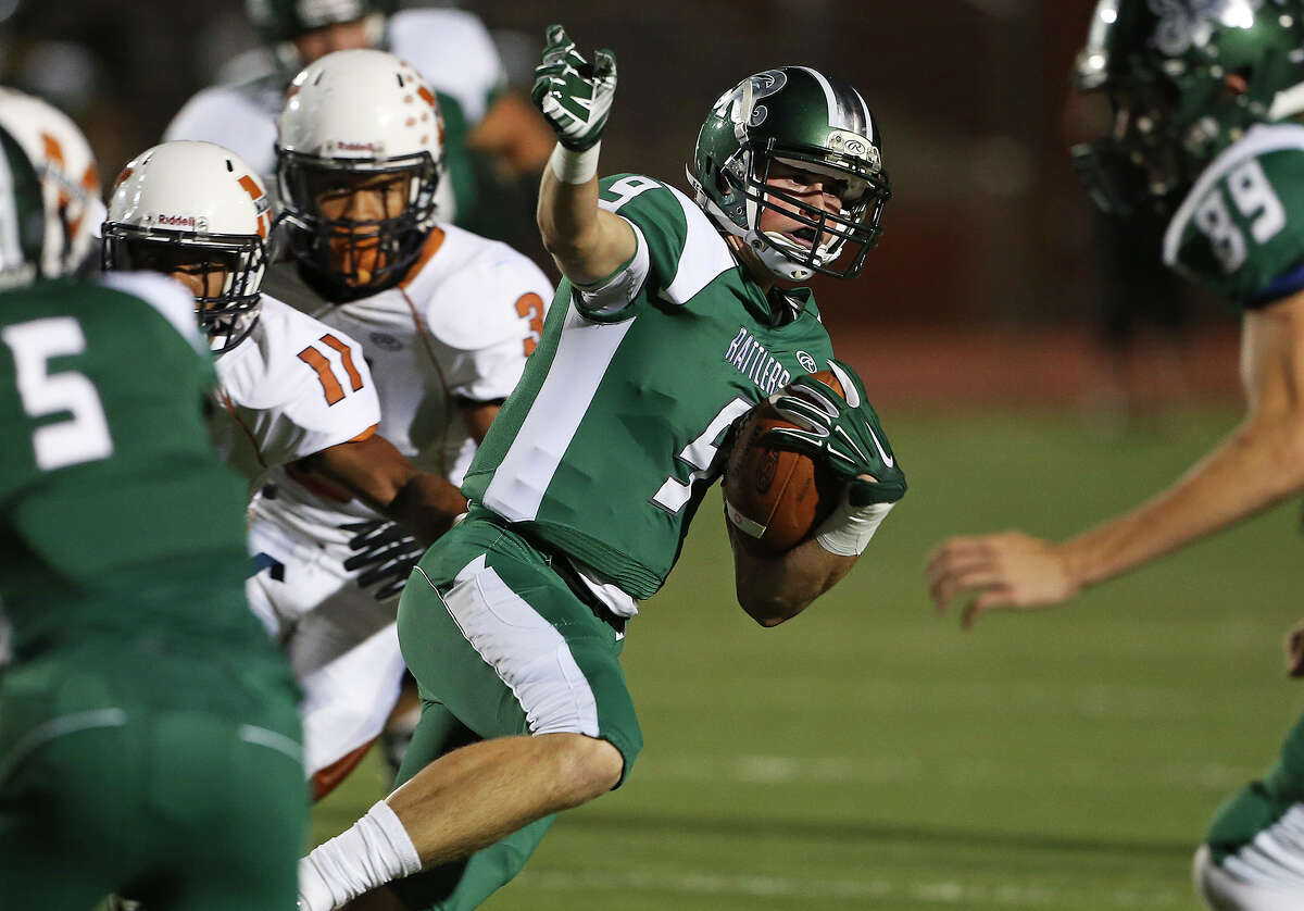 Cade Bormet turns to the outside for some running roomfor the Rattlers as Madison plays Reagan at Heroes Stadium on October 10, 2014.