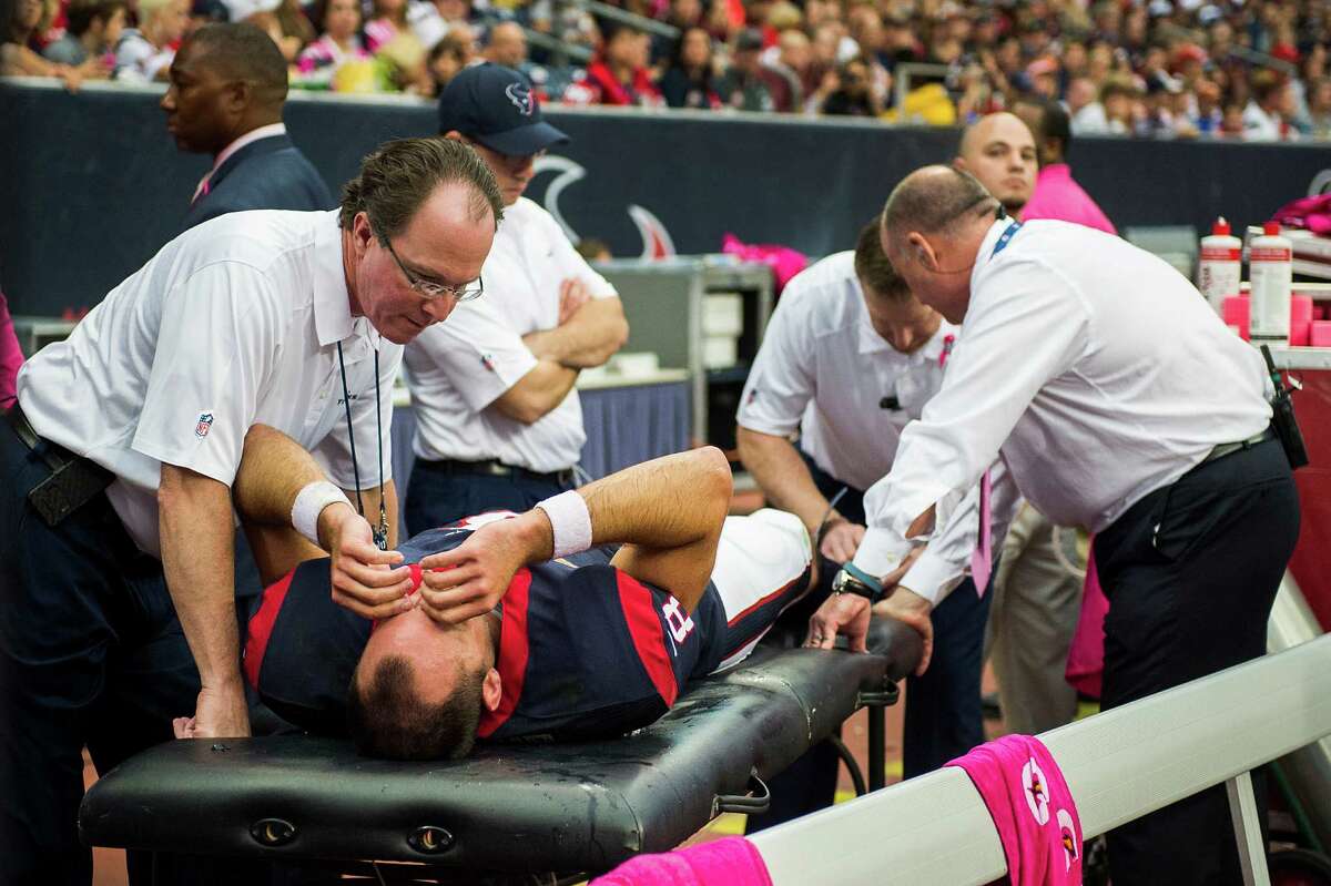 Texans quarterback Matt Schaub receives treatment on the right leg he injured in the third quarter - a wound that drew cheers from the Reliant Stadium and thus prompted shock and sorrow from the Rams.