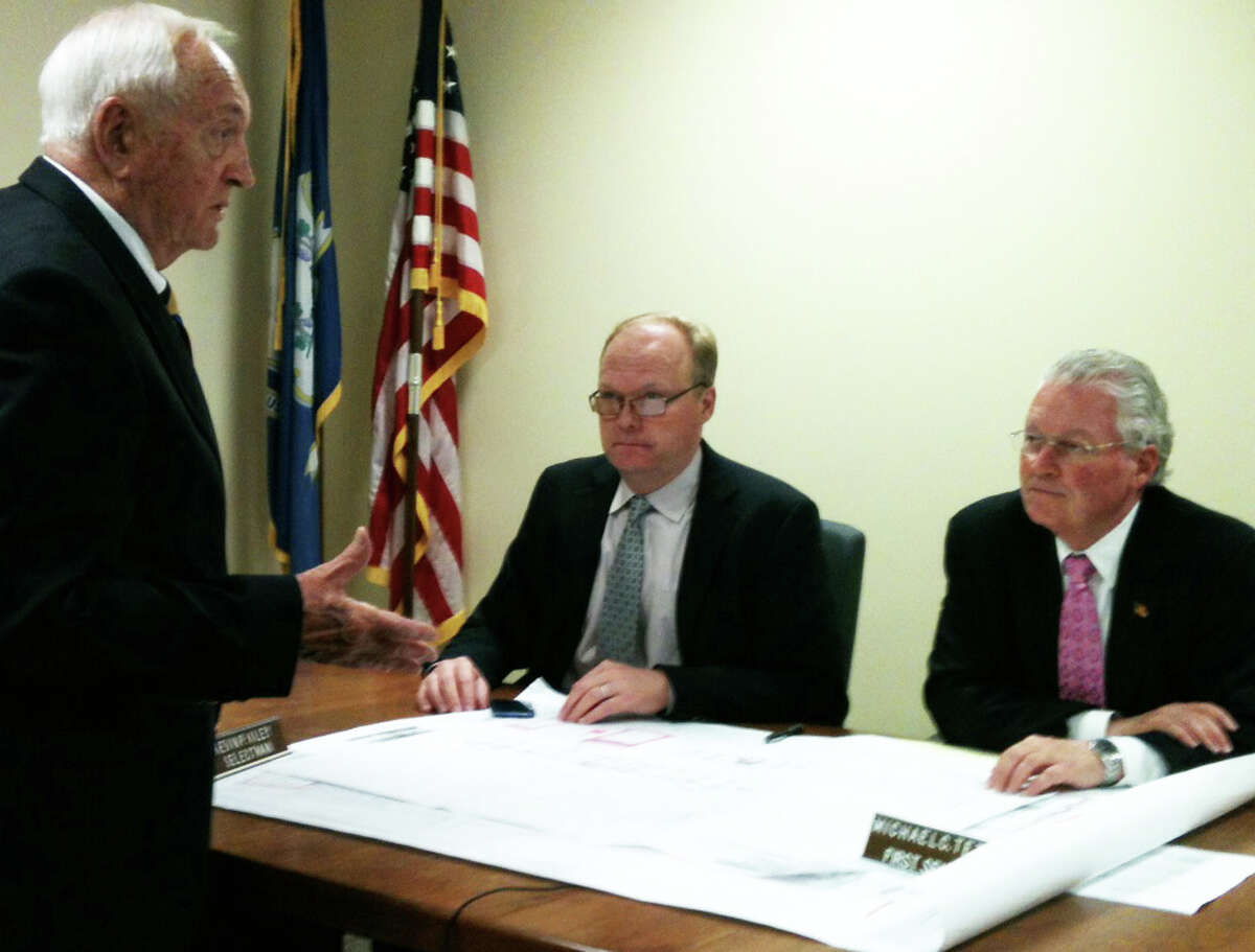 Former Town Attorney Roy Ervin, standing, discusses his proposed renovations to the exterior of Sullivan-Independence Hall with the Board of Selectmen last week. Seated are Selectman Kevin Kiley, left, and First Selectman Michael Tetreau.