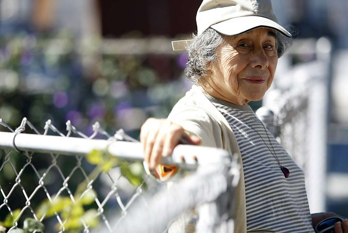 Lupe Quinones poses for a portrait in front of her home in Redwood City, CA Friday September 6, 2013. Lupe Quinones is a participant in a Stanford research project that has senior citizens walk around their neighborhoods and take photos and document problematic spots to collect data and advocate for changes on civic level.