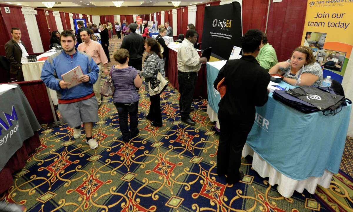 Job seekers look for employment opportunities during the Times Union Job Fair Monday morning, Oct. 14, 2013, at the Marriott on Wolf Road in Colonie, N.Y. (Skip Dickstein/Times Union)
