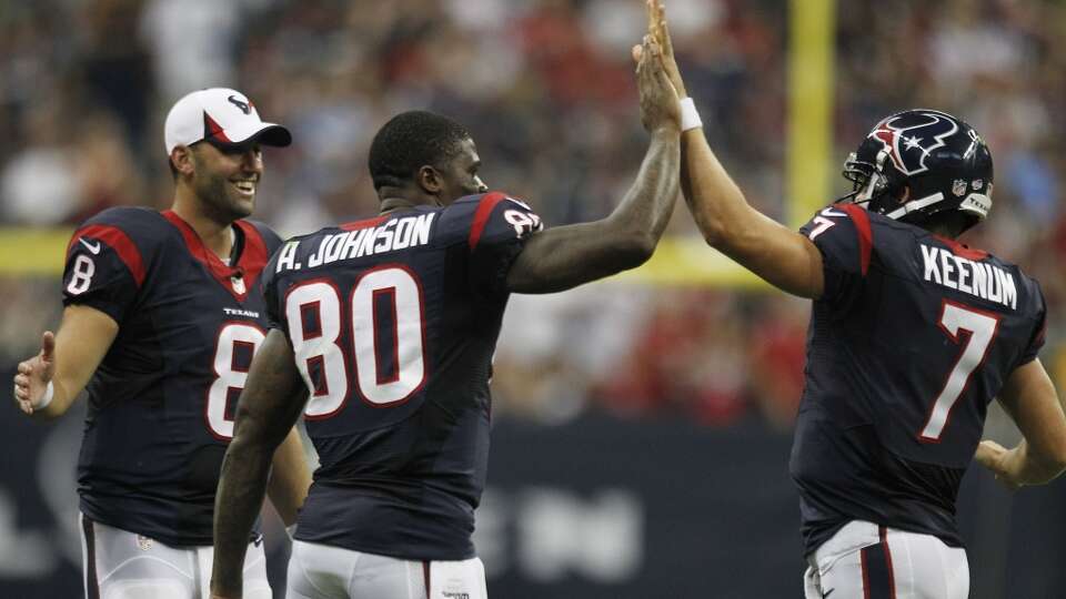 Case Keenum is congratulated by Texans' teammates Andre Johnson and Matt Schaub during preseason action.