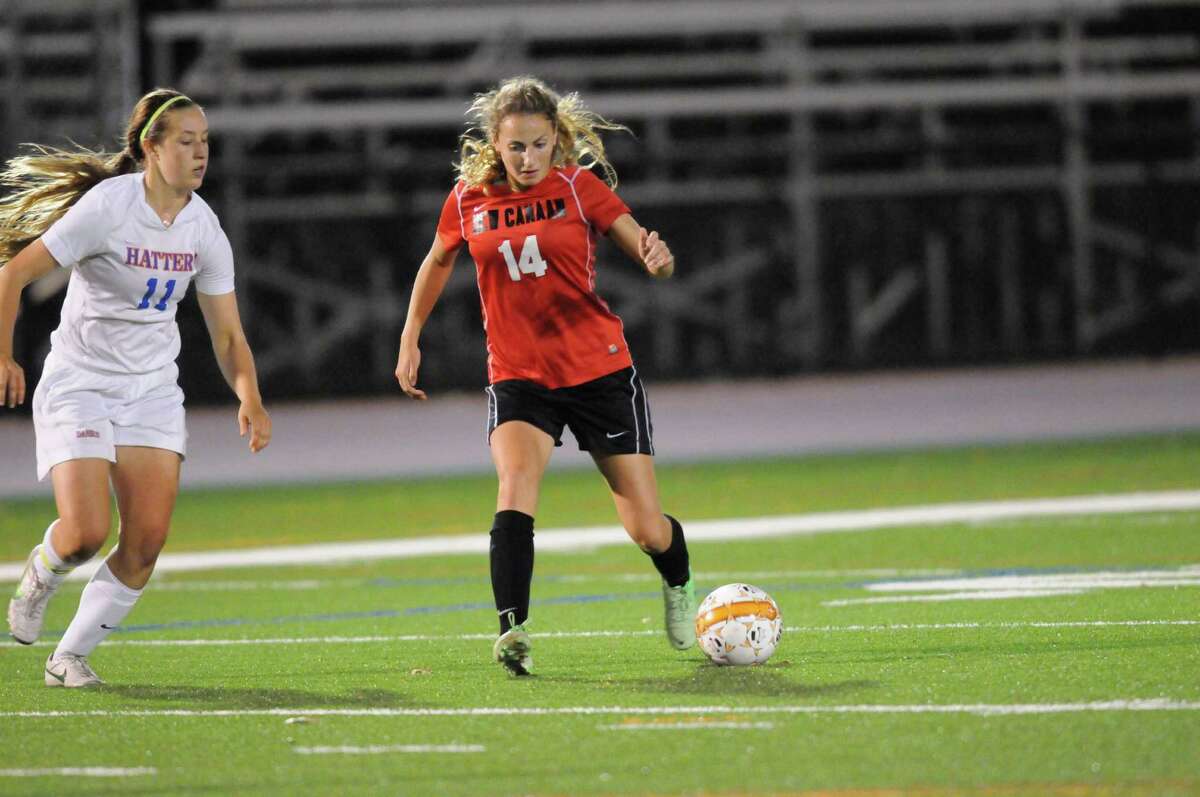 New Canaan's Marina Braccio (No. 14) charges down the field during Danbury's 2-1 win at Danbury High School on Monday, Oct. 14, 2013. By Dave Crandall