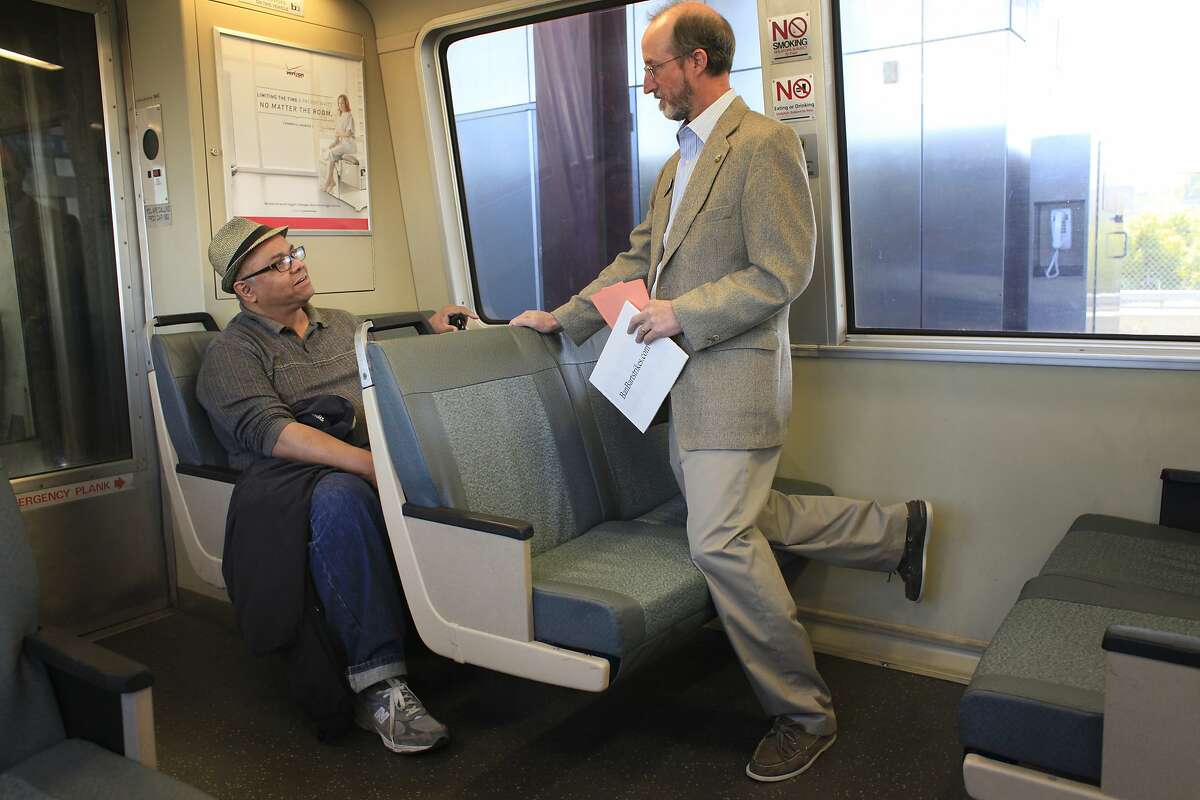 Talking to regular BART rider Frank Gonzalez, of Pittsburg, Orinda City Council member and banBARTstrikes.com organizer Steve Glazer campaigns to ban transit strikes in California by riding to all 44 BART stops on Monday, October 14, 2013 in Monday Oct. 14, 2013 in Orinda, Calif.