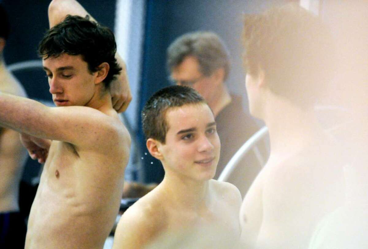 Greenwich diver Russell Lange, center, chats with diver Connor Brisson, right, and Mark O'Connell waits to dive again as Greenwich High hosts Ridgefield High in a boys swim meet Wednesday afternoon, January 27, 2010.