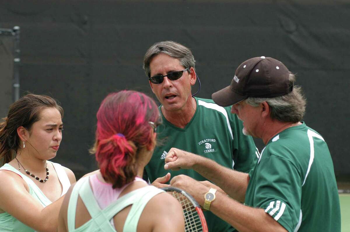 Stratford tennis head coach Rory Frazee (in sunglasses facing camera) talks with his girls doubles team of Carlene Leyden (far left) and Lucy Herrera (red in hair with back to camera) at the UIL State Tournament in Austin on May 7, 2007. Also pictured is Stratford assistant coach Tom Courson (far right in hat). The Stratford girls fell to Corpus Christi Carroll's Jacquelyn Garza and Megan Garcia 6-4, 6-2 in the Class 5A state quarterfinals at the University of Texas Penick-Allison Courts.