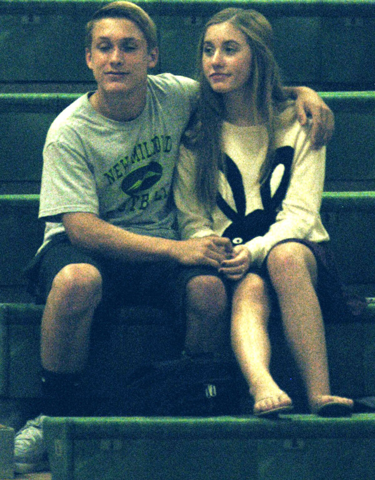 Green Wave fans bond in support of the team during New Milford High School volleyball's 3-1 victory over visiting Kolbe Cathedral, Oct. 7, 2013 at NMHS.