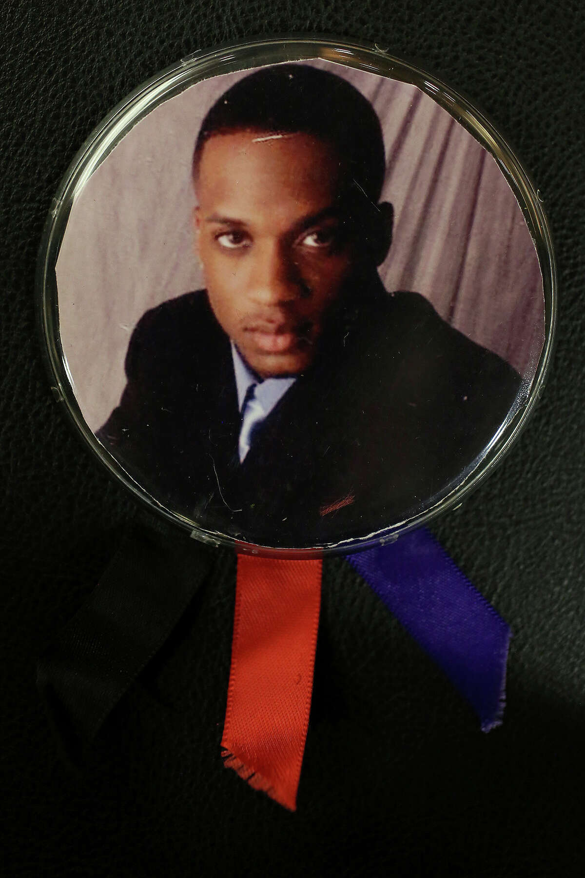 A button with a photograph of Samuel Johnson, Jr. carried by his mother, Stephanie Johnson, during the trial of Bernard "B.J." Brown, for the murder of her son in the 379th District Court in San Antonio on Tuesday, Oct. 8, 2013.